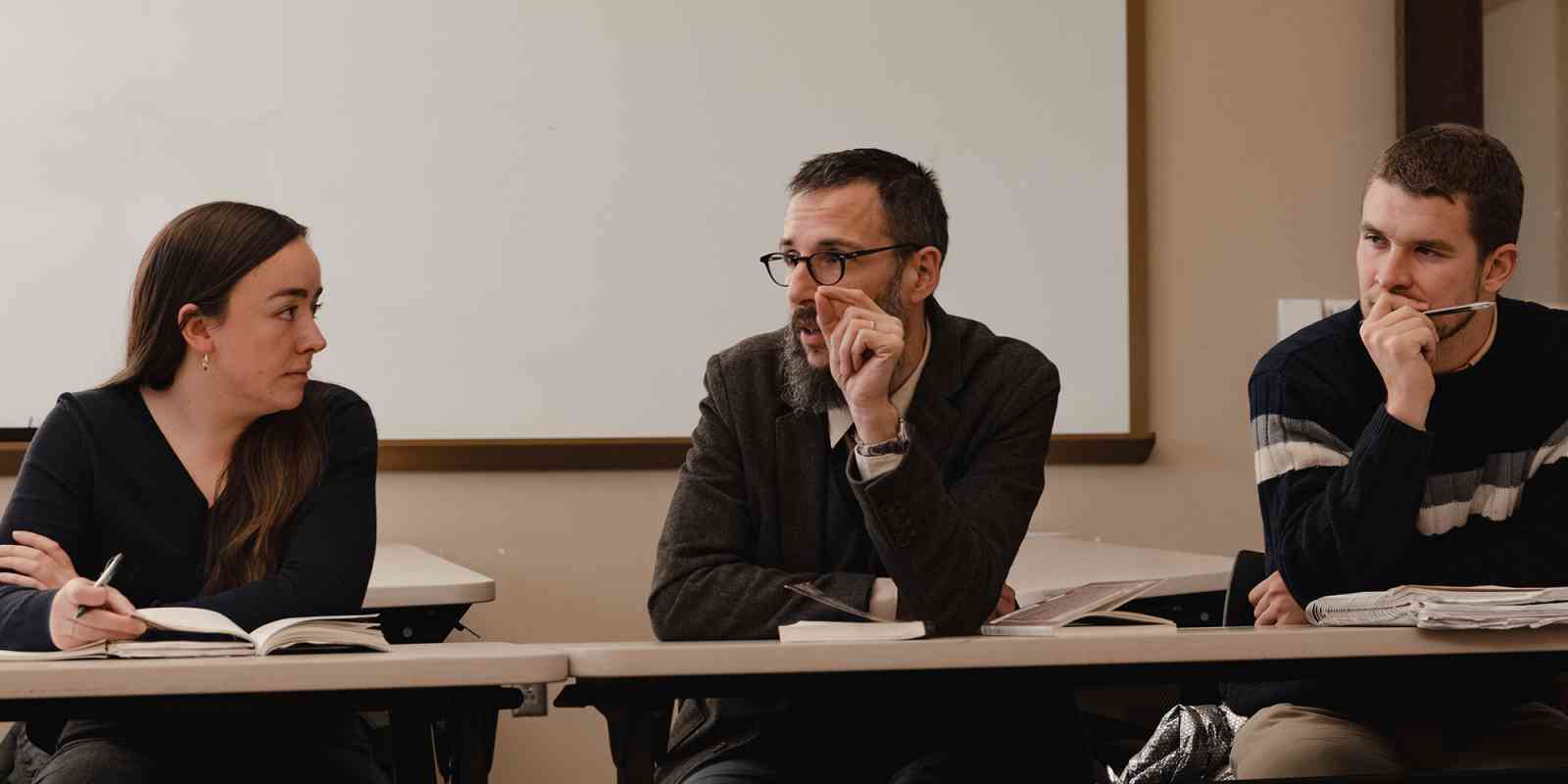A professor makes a point in a seminar Honors class