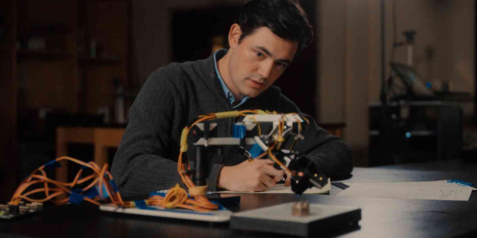 A student at Benedictine College works with a robot arm in an Engineering lab.
