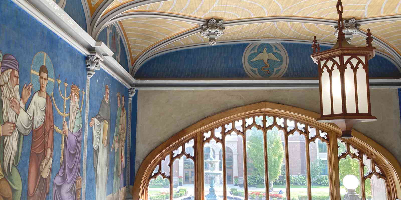 Entrance to St. Benedict Hall with the mural partly visible.