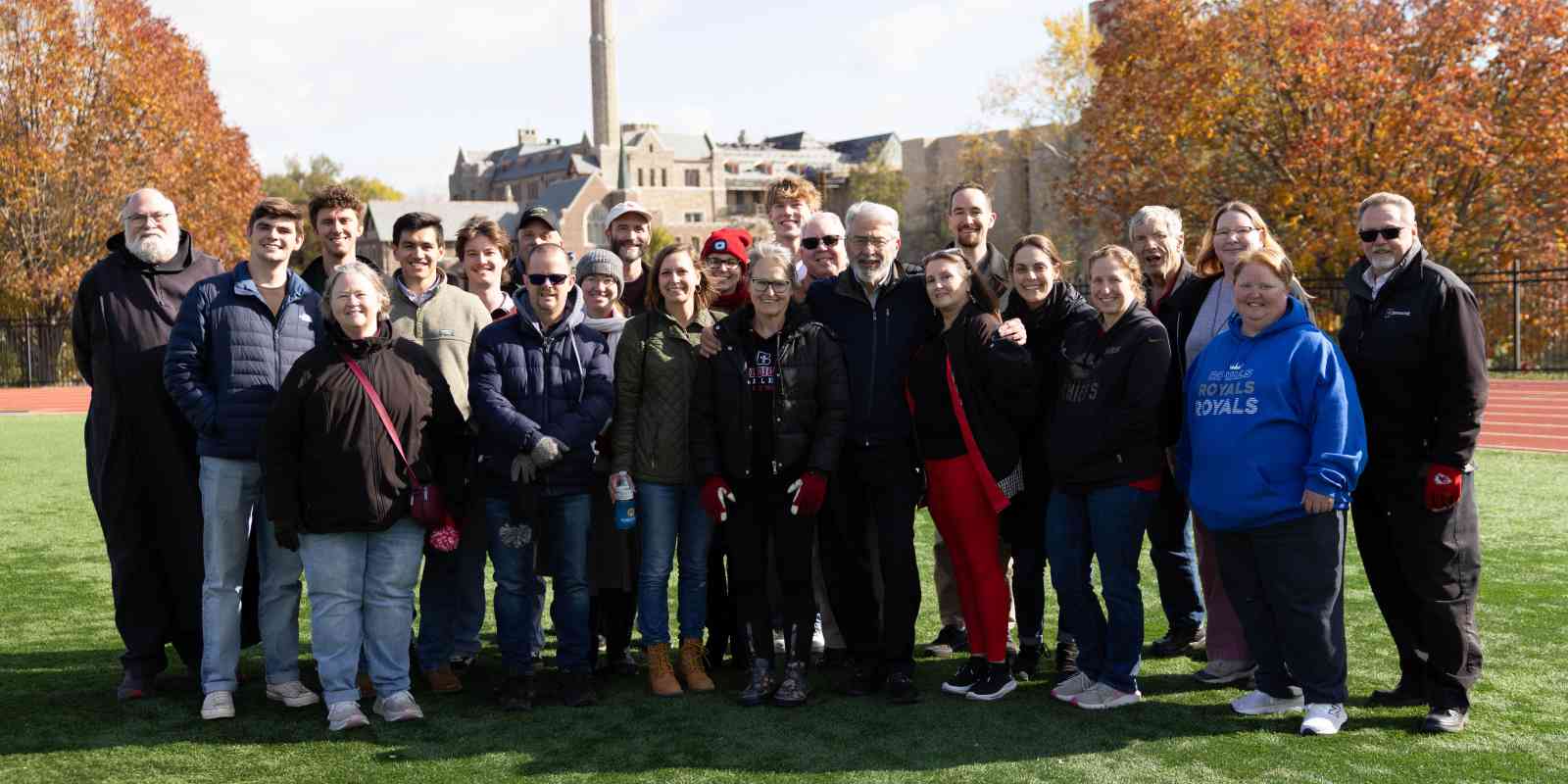 Members of the Hunger Coalition, past and present, pose for a photo during the football halftime recognition on Nov. 1